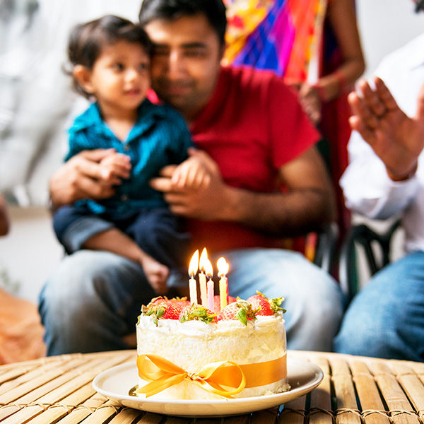A-family-around-a-cake-singing-happy-birthday