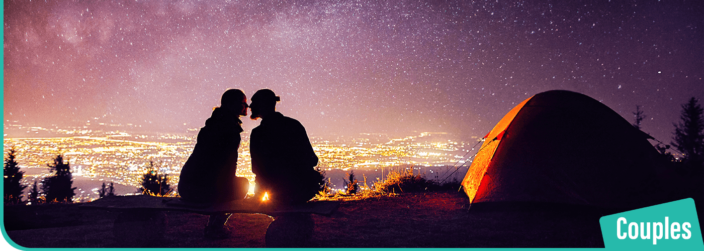 A-couple-on-a-date-night-overlooking-a-city-of-lights-under-the-stars