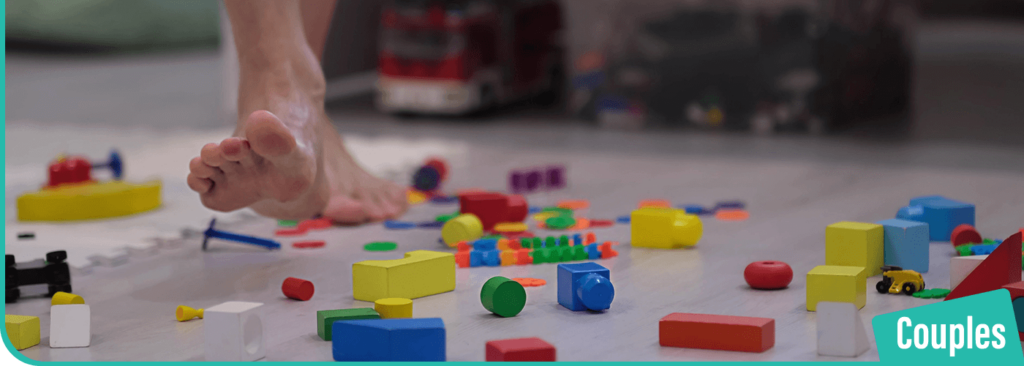A-man-stepping-with-his-barefoot-on-lego-blocks