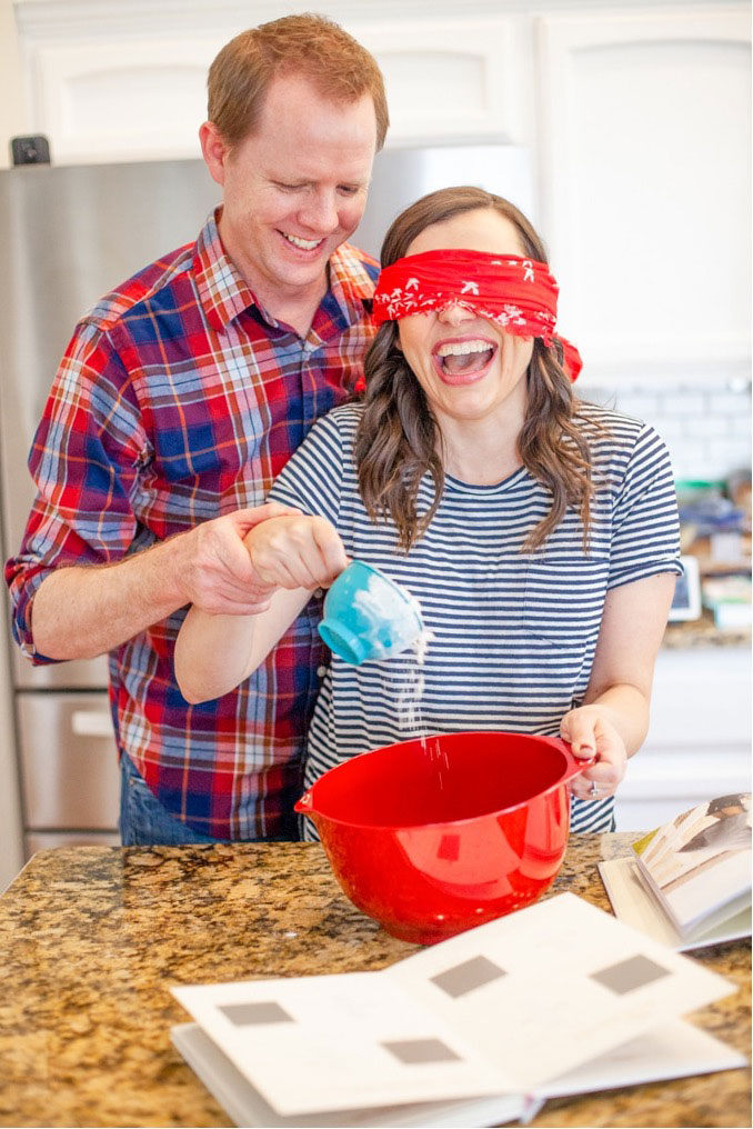 Couple-laughing-while-baking-blindfolded