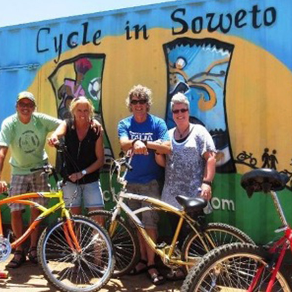 Cyclist-in-front-of-Cycle-in-Soweto-Sign